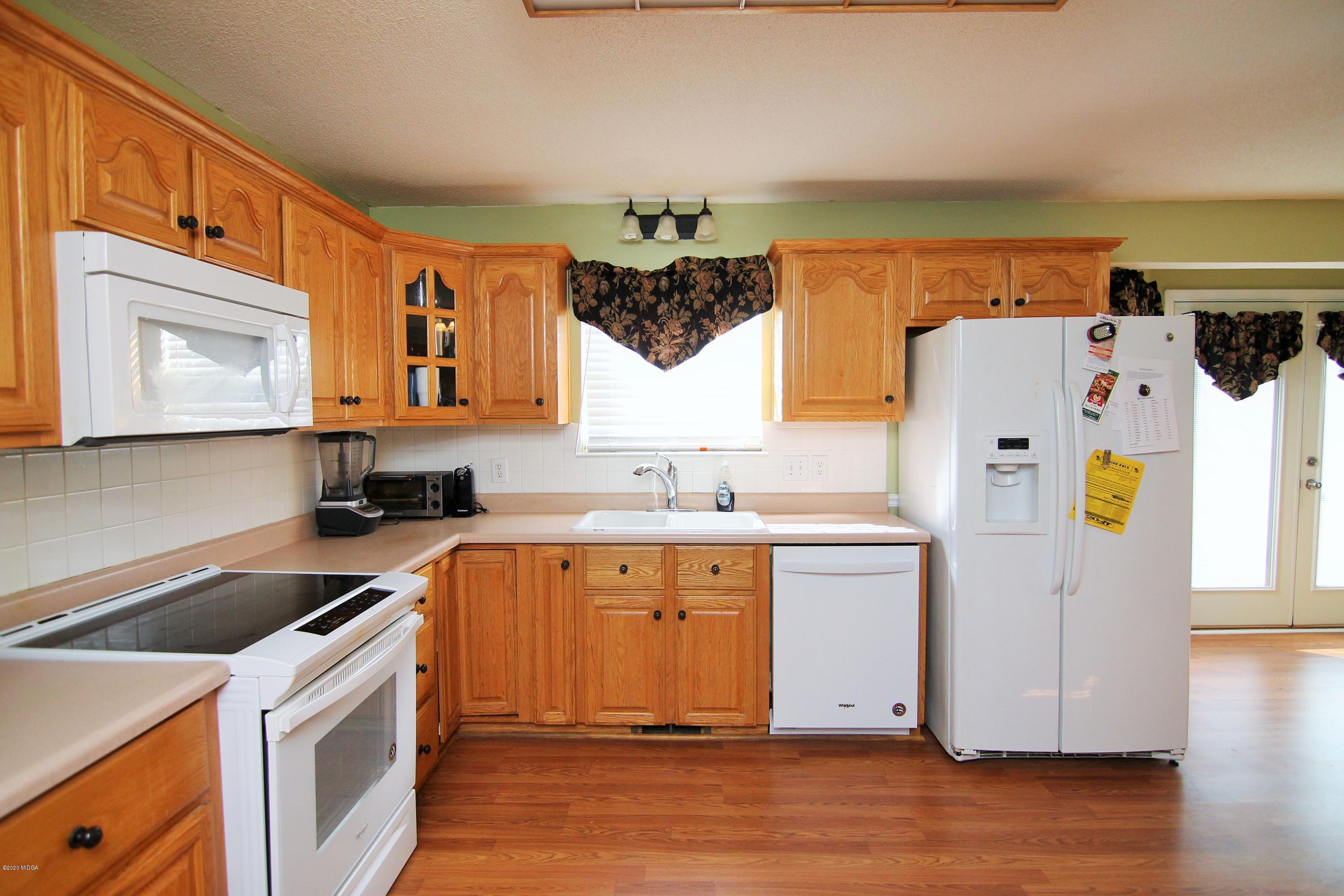 226 Ruben Road Byron, GA 31008 - Photo 13 of 30 a kitchen with a sink a refrigerator and window