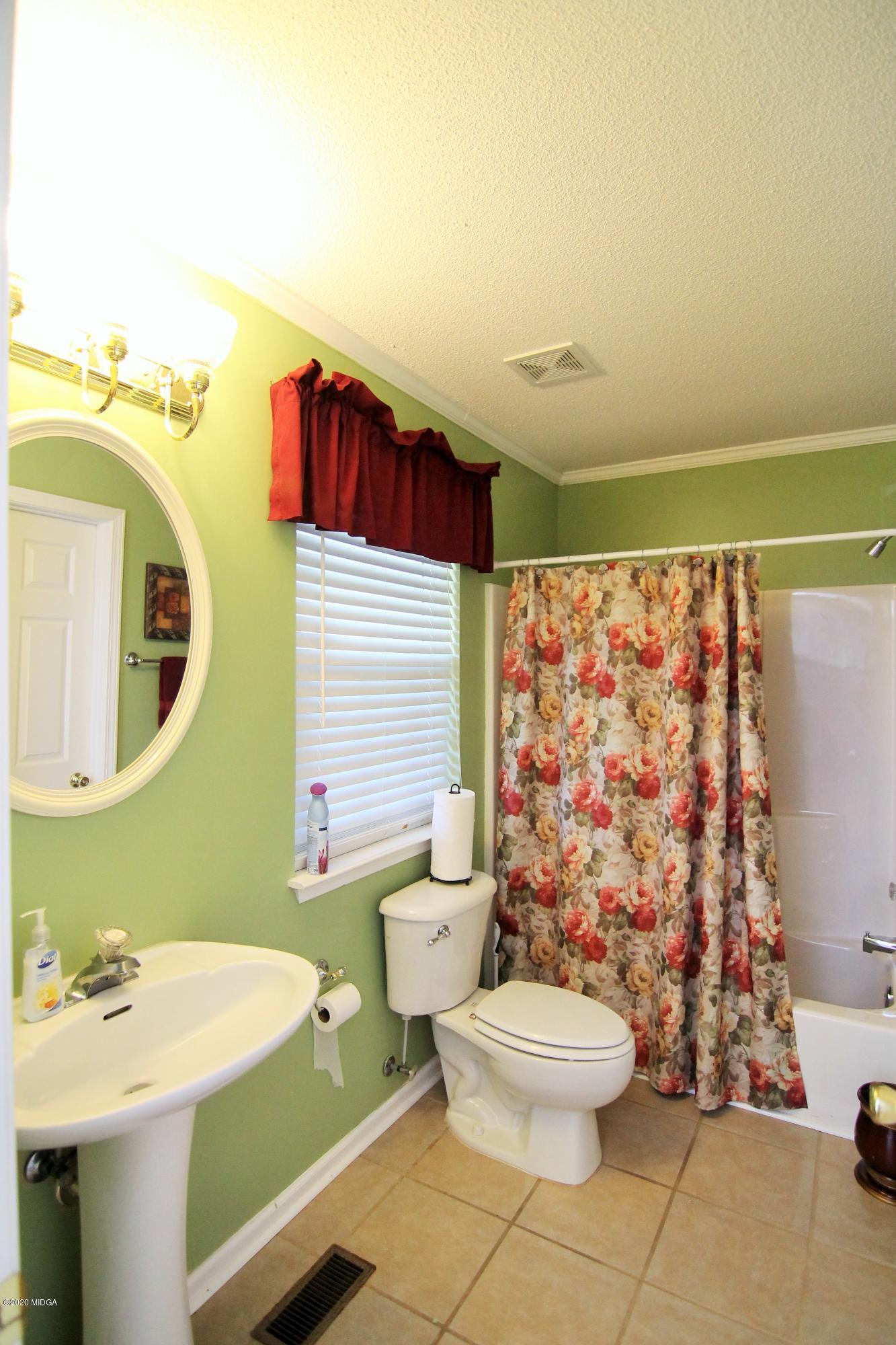 226 Ruben Road Byron, GA 31008 - Photo 15 of 30 a bathroom with a sink toilet and shower