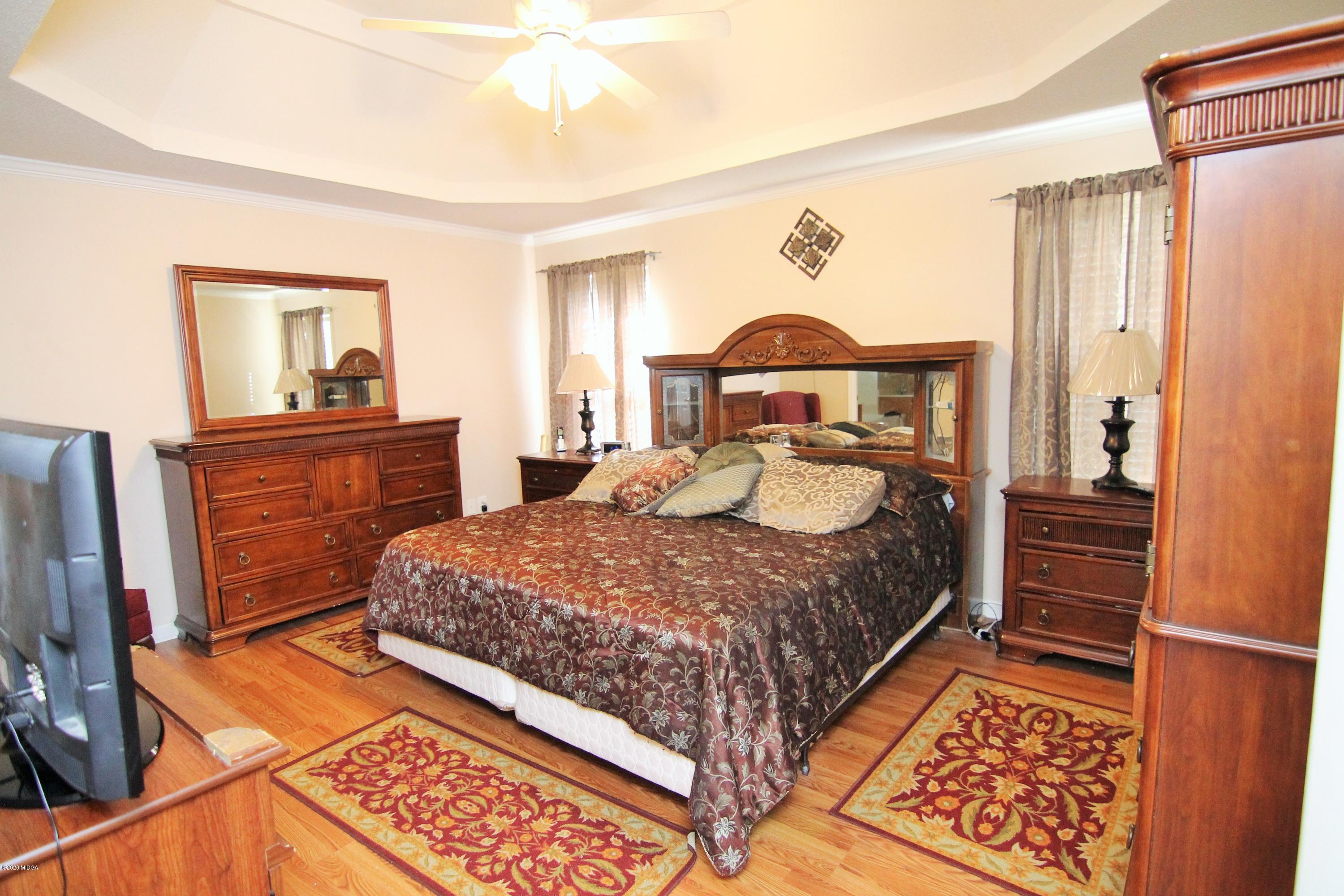 226 Ruben Road Byron, GA 31008 - Photo 16 of 30 a bed room with a bed and a dresser