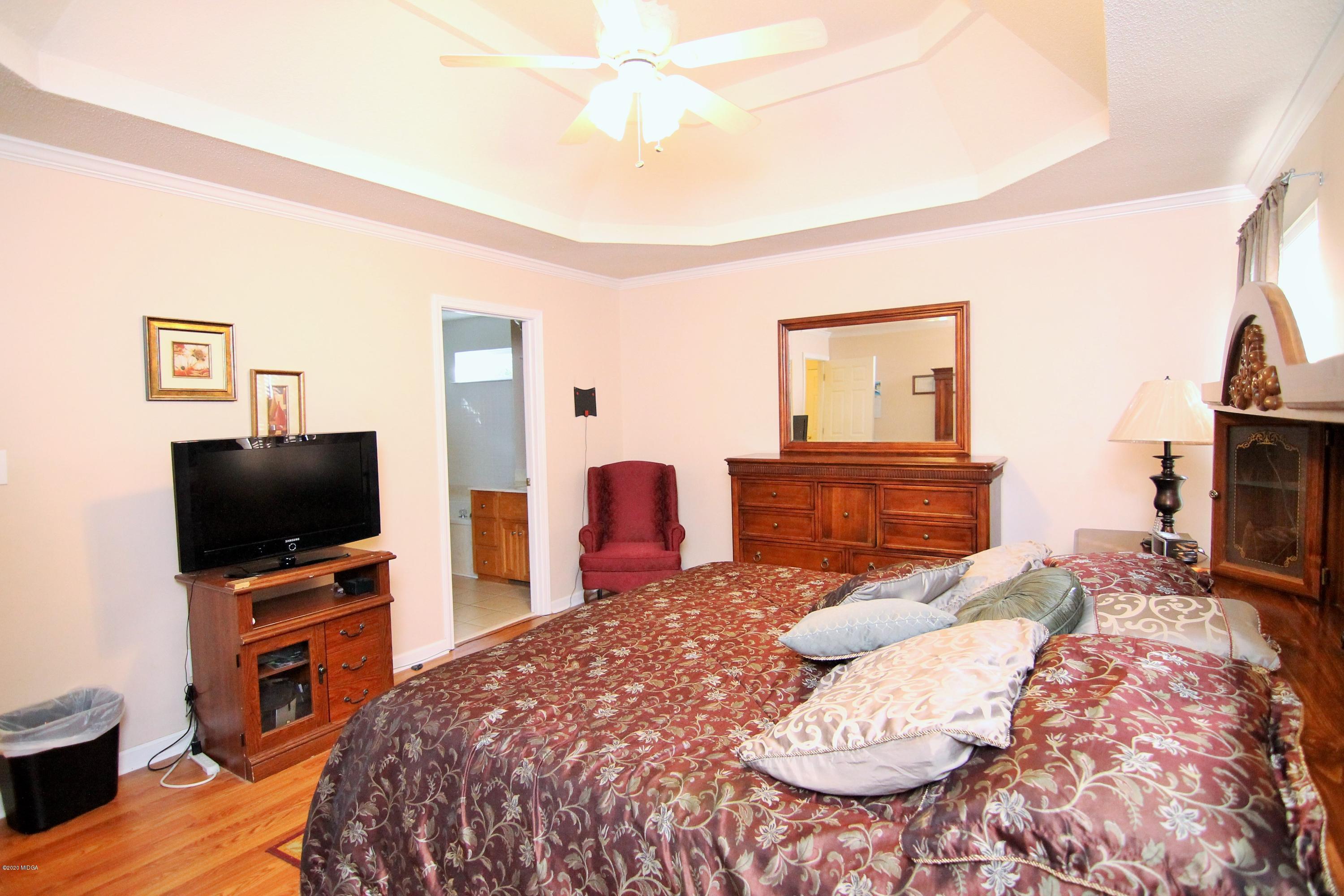 226 Ruben Road Byron, GA 31008 - Photo 17 of 30 a bedroom with a bed and a television