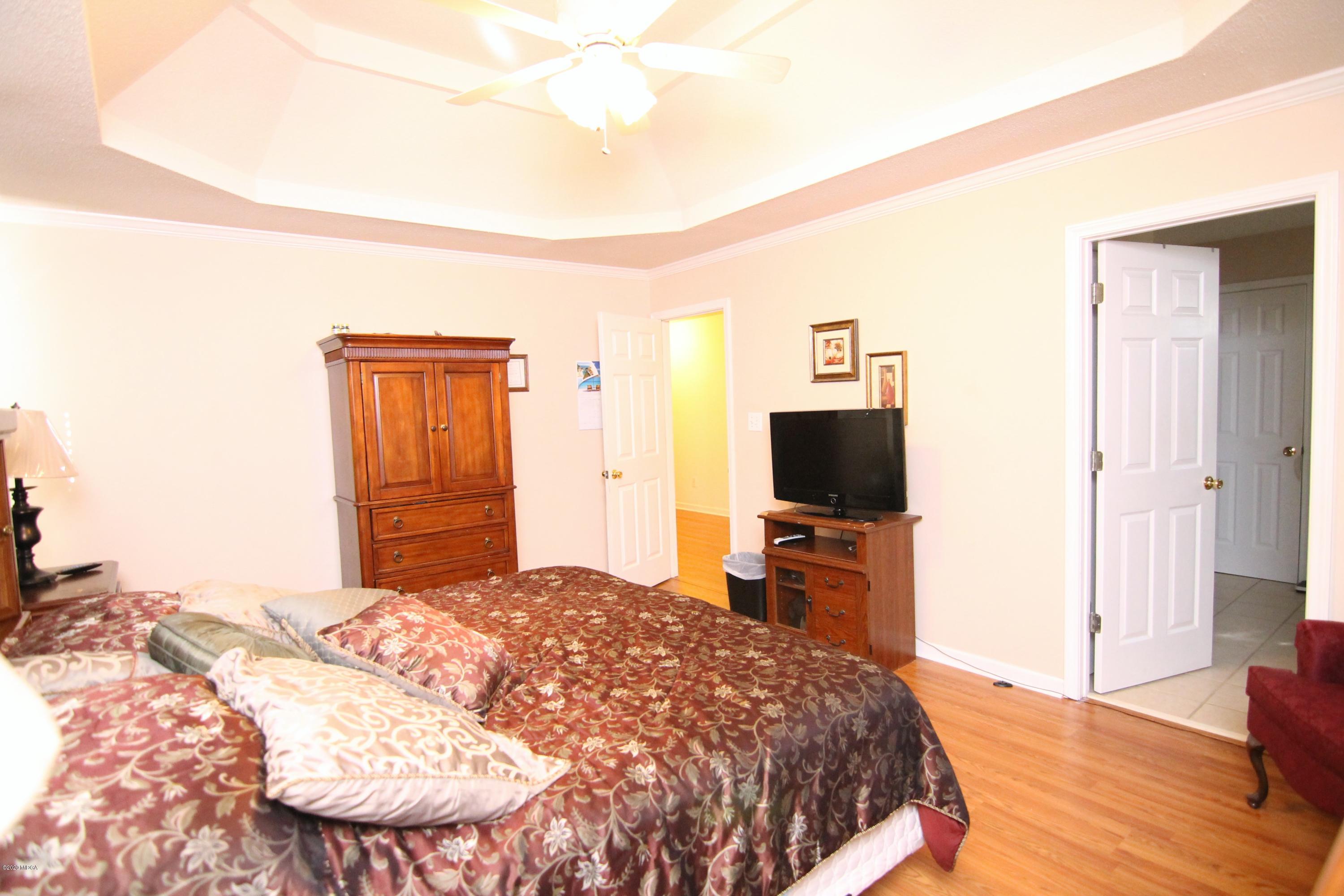 226 Ruben Road Byron, GA 31008 - Photo 18 of 30 a bedroom with a bed and a flat screen tv