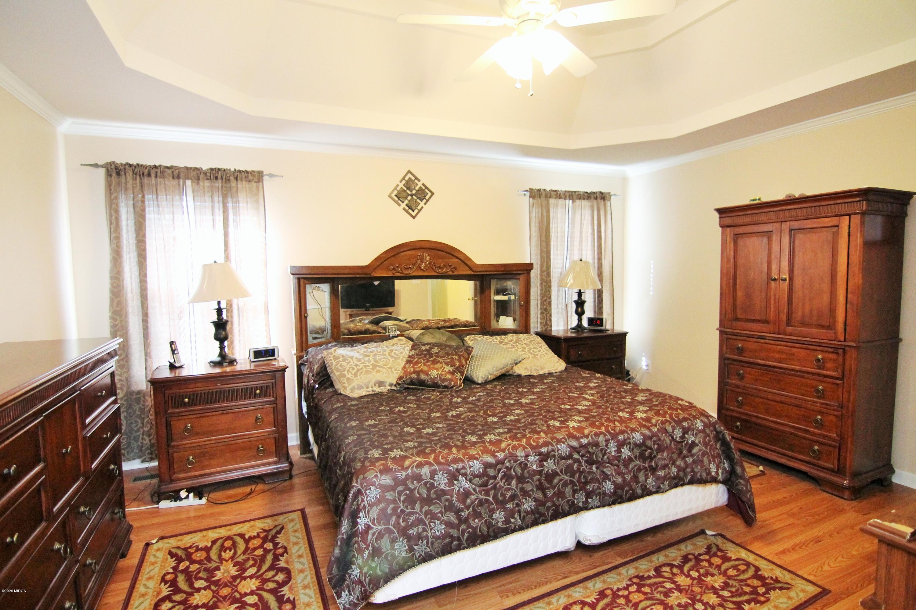 226 Ruben Road Byron, GA 31008 - Photo 19 of 30 a bedroom with a bed and dresser
