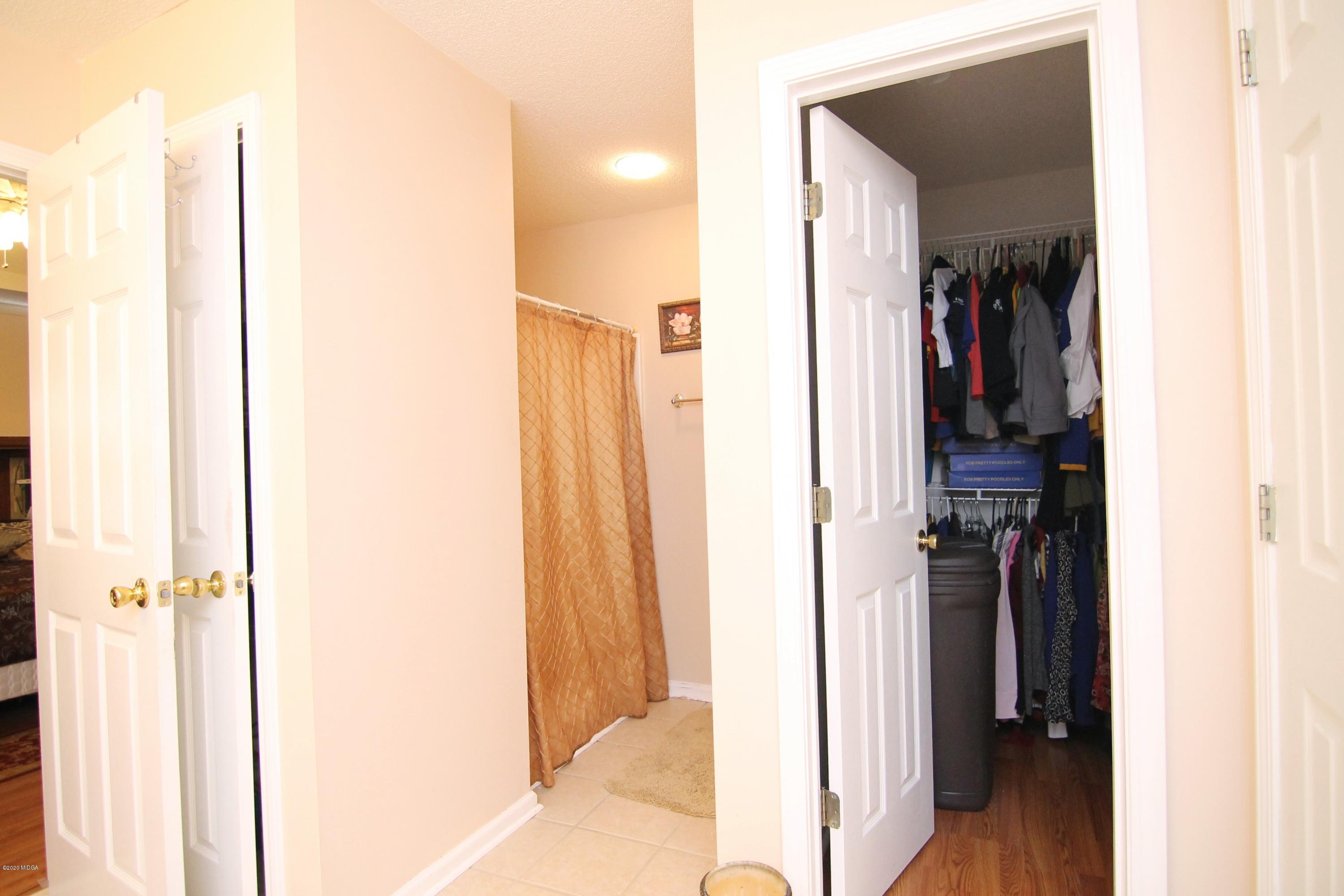 226 Ruben Road Byron, GA 31008 - Photo 21 of 30 a view of walk in closet with clothes and shoes