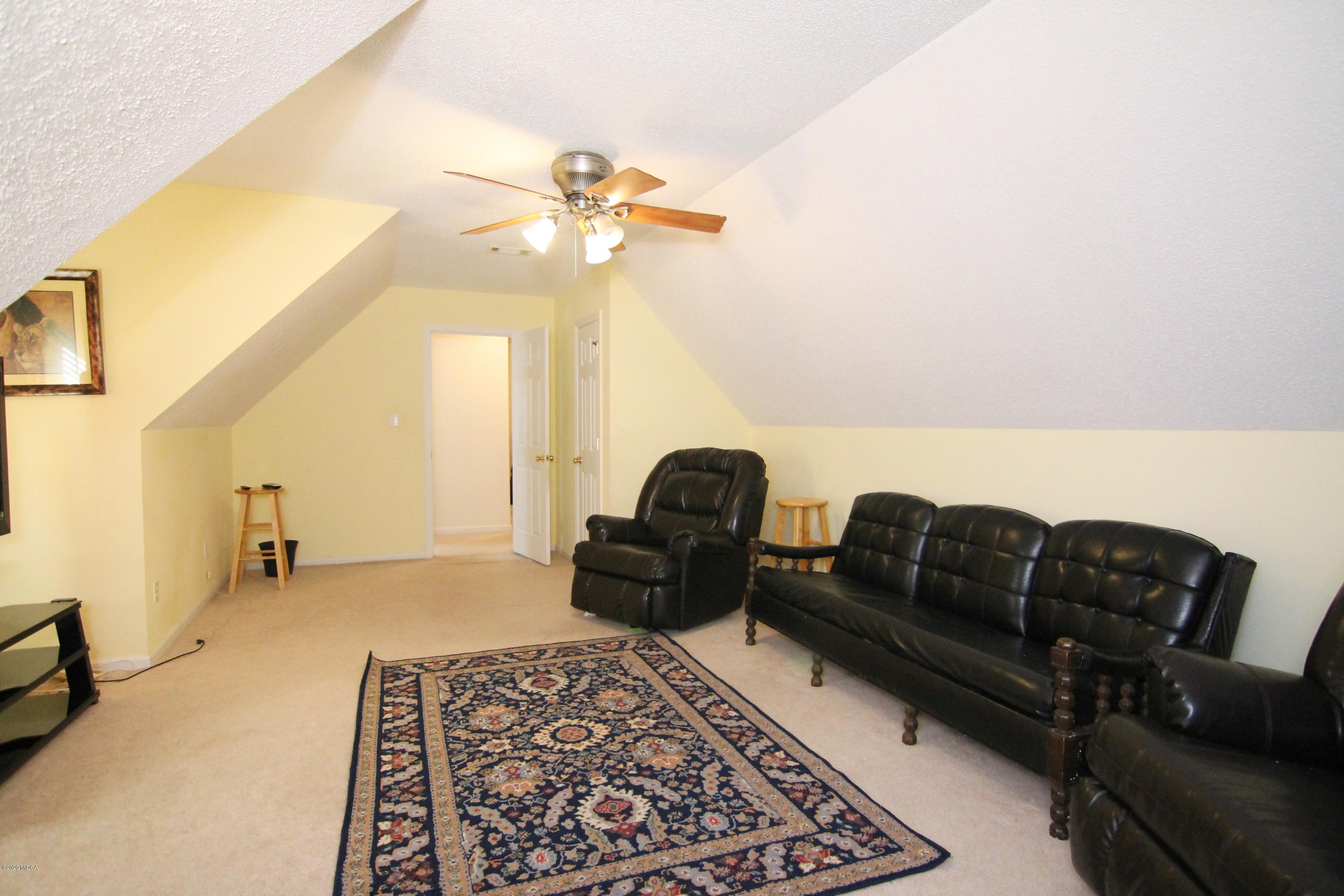 226 Ruben Road Byron, GA 31008 - Photo 25 of 30 a living room with furniture ceiling fan and a rug