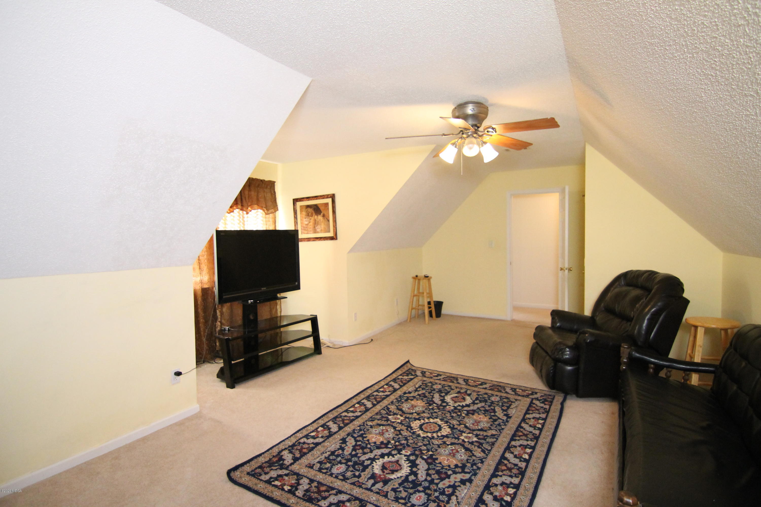 226 Ruben Road Byron, GA 31008 - Photo 26 of 30 a living room with furniture and a flat screen tv