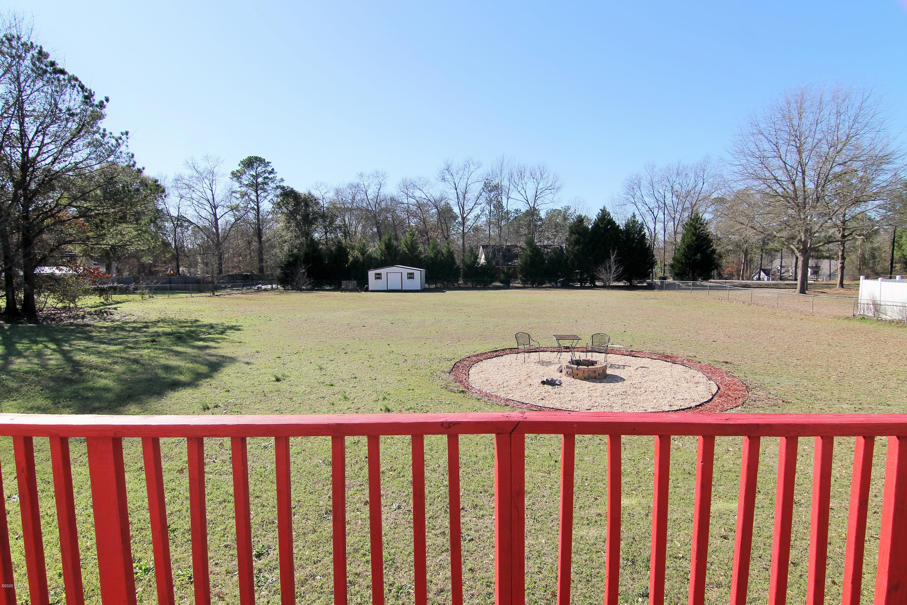 226 Ruben Road Byron, GA 31008 - Photo 30 of 30 a view of a yard with mountain and wooden floor