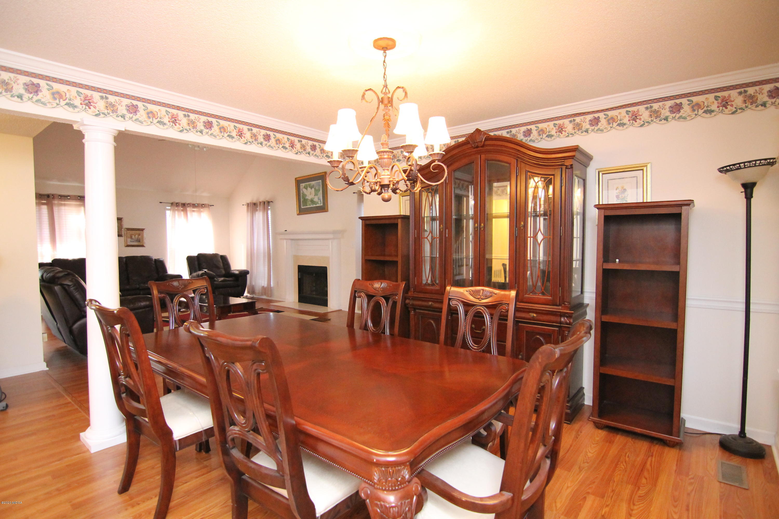 226 Ruben Road Byron, GA 31008 - Photo 4 of 30 a dining room with furniture a chandelier and wooden floor