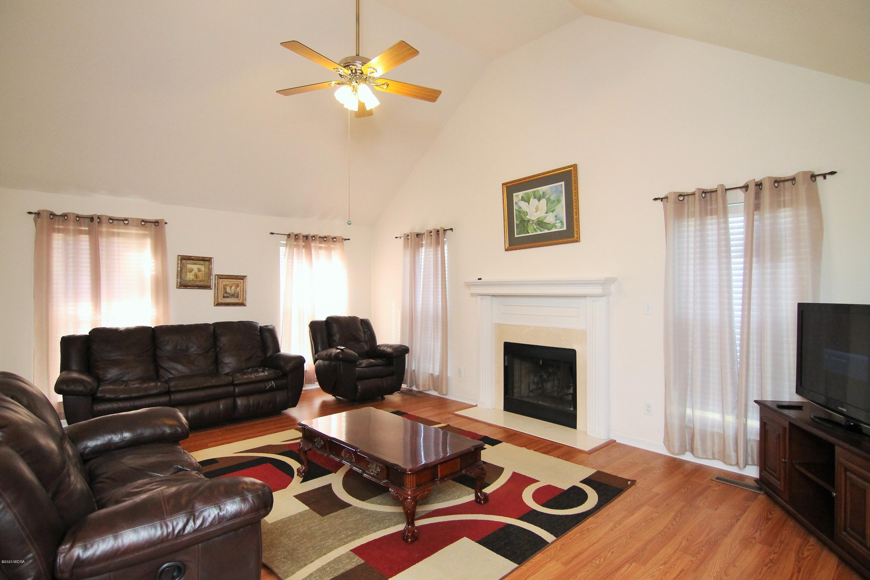 226 Ruben Road Byron, GA 31008 - Photo 6 of 30 a living room with furniture fireplace and flat screen tv