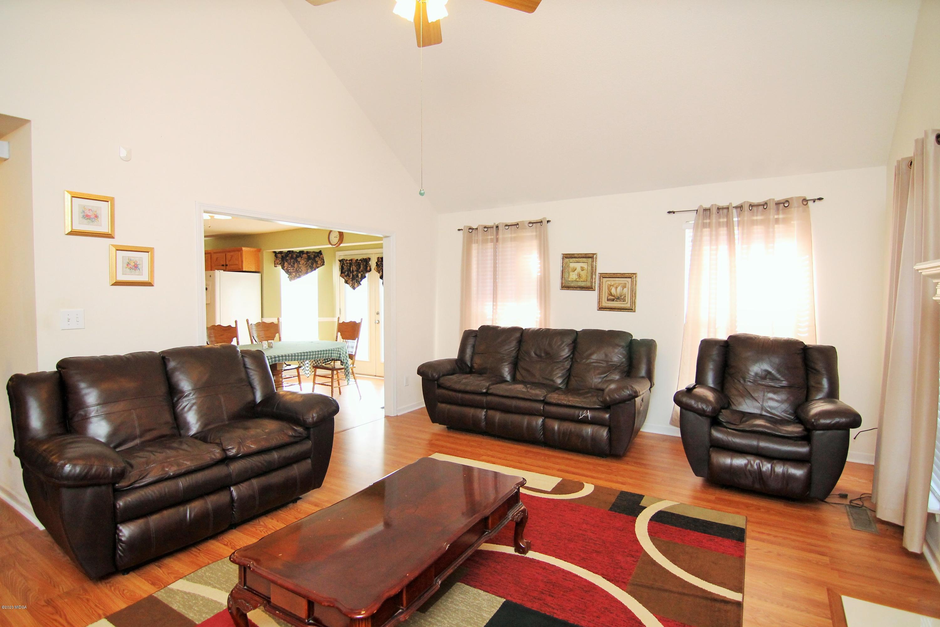 226 Ruben Road Byron, GA 31008 - Photo 7 of 30 a living room with furniture ceiling fan and a window