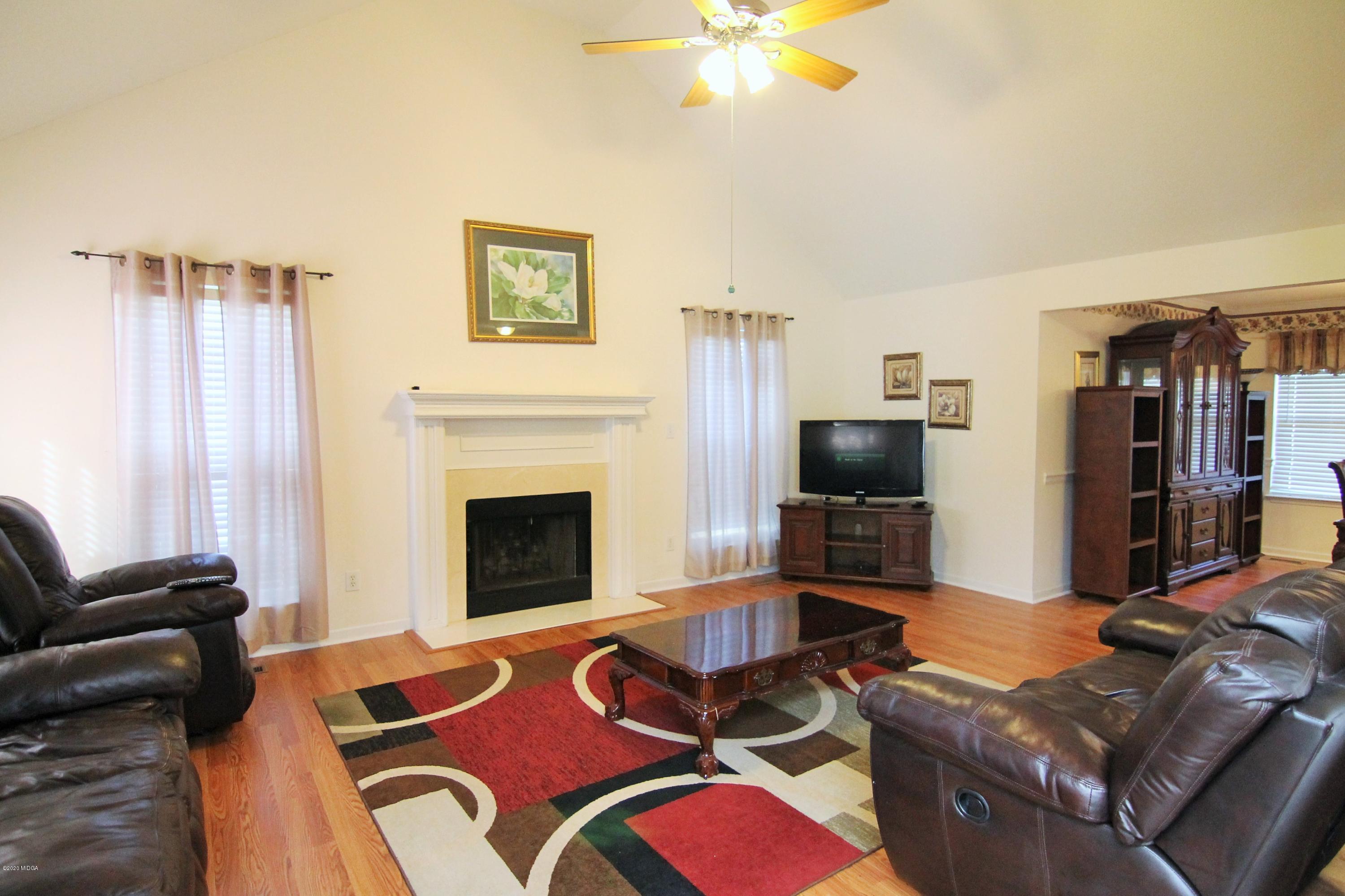 226 Ruben Road Byron, GA 31008 - Photo 8 of 30 a living room with furniture and a fireplace