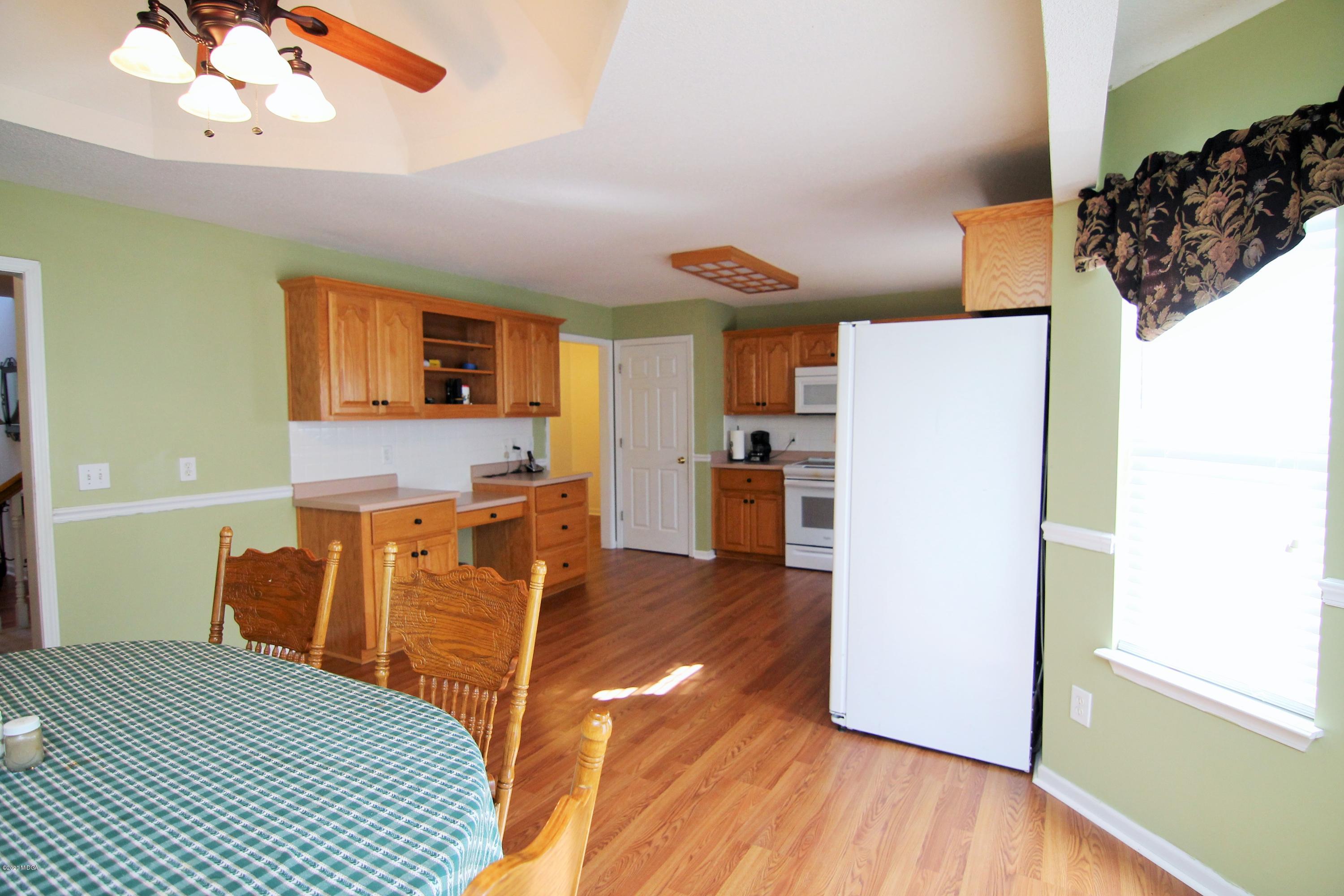 226 Ruben Road Byron, GA 31008 - Photo 10 of 30 a bedroom with a bed and wooden floor