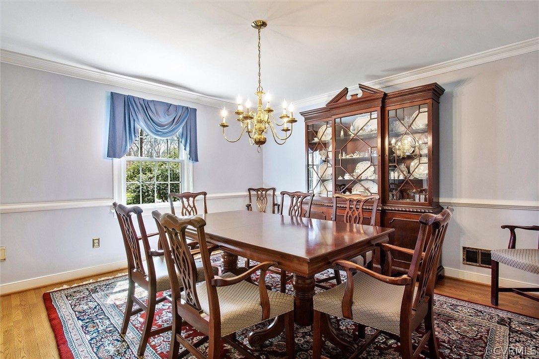 2800 Queenswood Road Midlothian, VA 23113 - Photo 17 of 45 a view of a dining room with furniture a chandelier and wooden floor