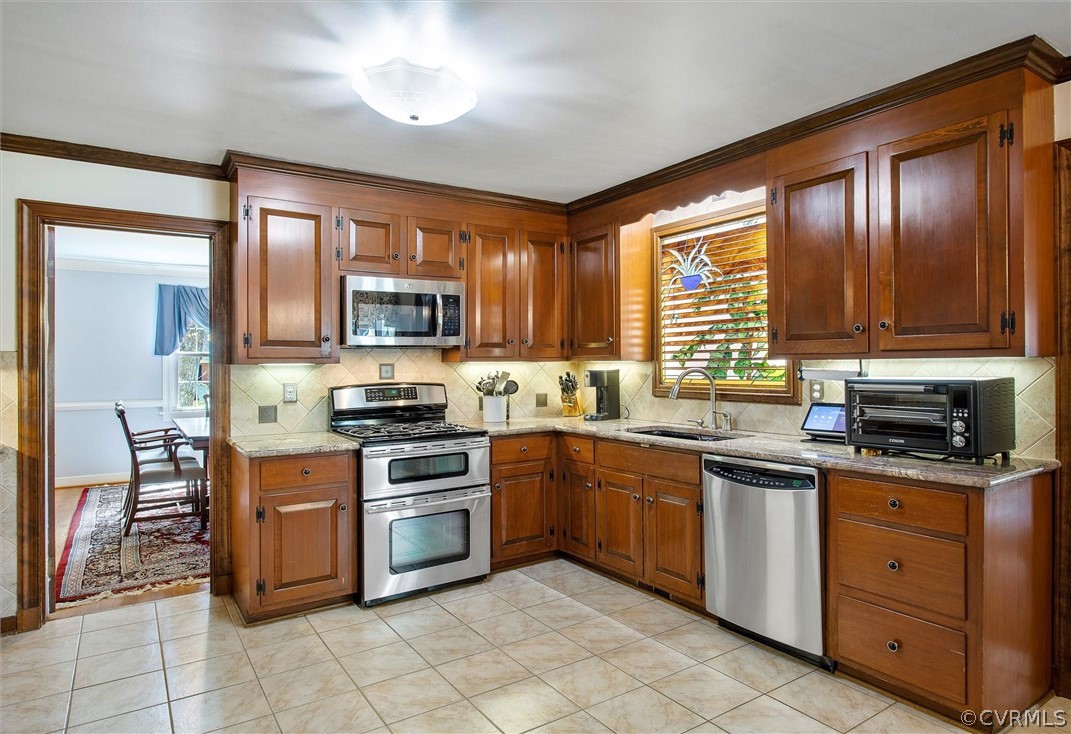 2800 Queenswood Road Midlothian, VA 23113 - Photo 10 of 45 a kitchen with stainless steel appliances granite countertop wooden cabinets a stove top oven a sink and dishwasher