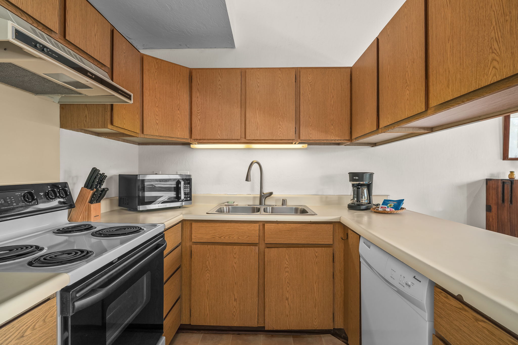 1901 Poipu Road, Unit 832 Koloa, HI 96756 - Photo 11 of 19 a kitchen with stainless steel appliances granite countertop a sink stove and cabinets
