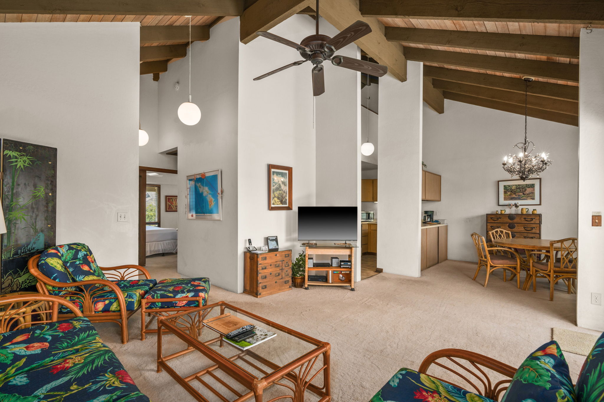 1901 Poipu Road, Unit 832 Koloa, HI 96756 - Photo 5 of 19 a bedroom with furniture and a chandelier