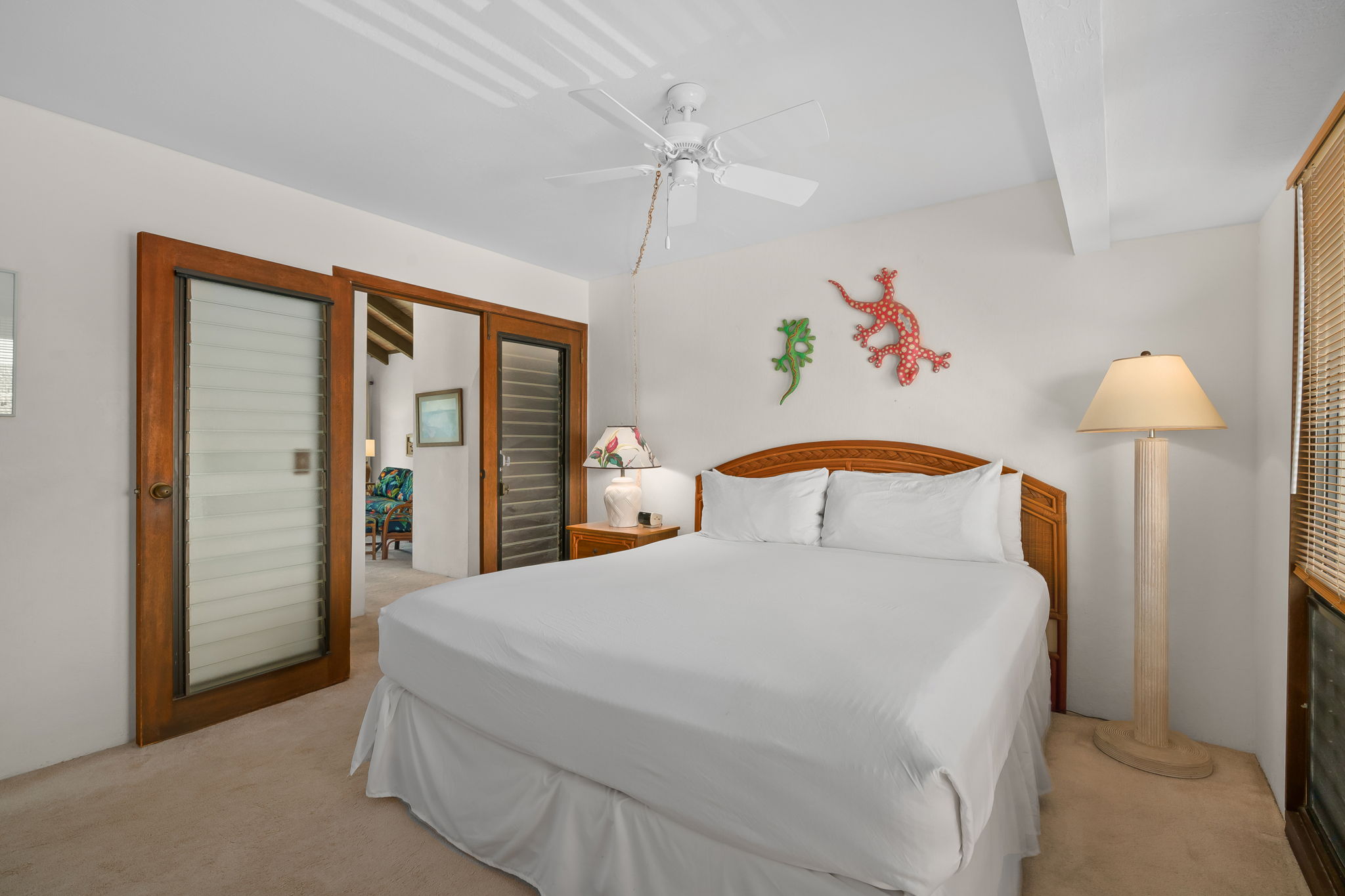 1901 Poipu Road, Unit 832 Koloa, HI 96756 - Photo 7 of 19 a bedroom with a large bed and a chandelier