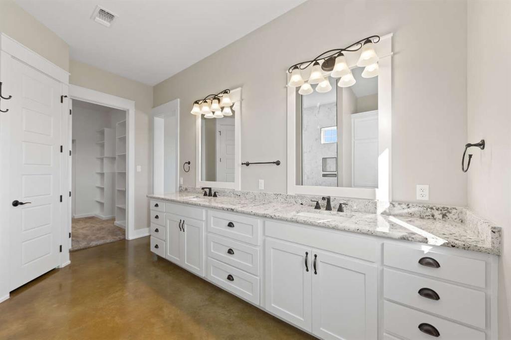 3 Quarter Loop Poolville, TX 76487 - Photo 22 of 40 a bathroom with a double vanity sink mirror and double