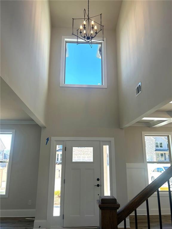 4265 Trinity Oaks Trail Cumming, GA 30040 - Photo 7 of 25 a view of a hallway with windows and chandelier