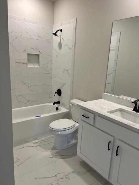 4265 Trinity Oaks Trail Cumming, GA 30040 - Photo 10 of 25 a bathroom with a granite countertop toilet a sink and bathtub
