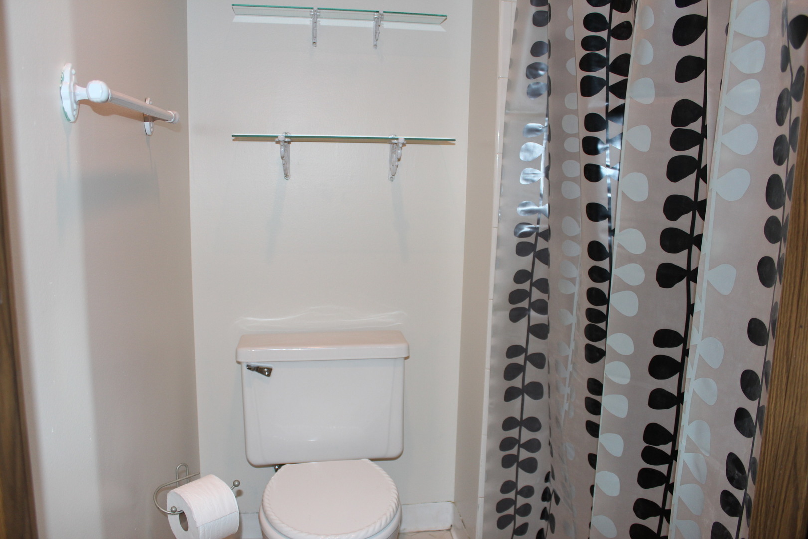 565 Dunham Road Gurnee, IL 60031 - Photo 11 of 17 a white toilet sitting next to a shower curtain