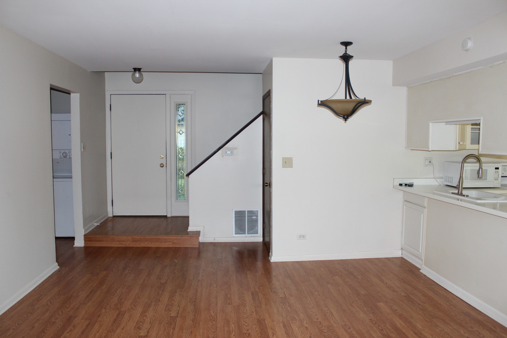 565 Dunham Road Gurnee, IL 60031 - Photo 3 of 17 a view of empty room with wooden floor and fan