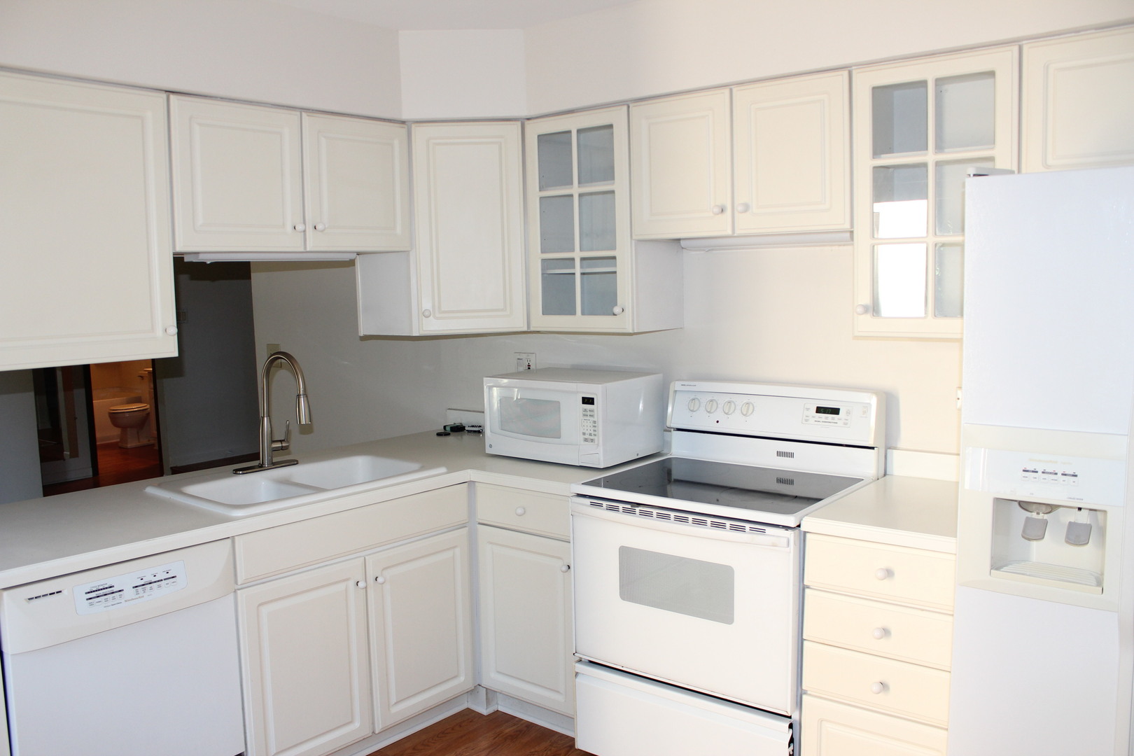 565 Dunham Road Gurnee, IL 60031 - Photo 5 of 17 a kitchen with granite countertop white cabinets and white appliances