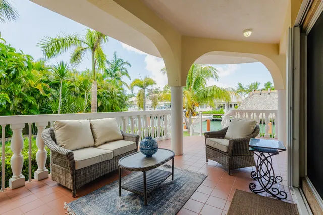 a balcony with furniture and a potted plant