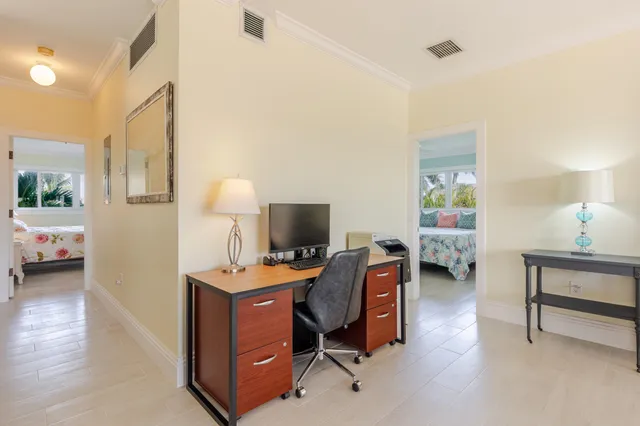 a kitchen with a table chairs refrigerator and microwave