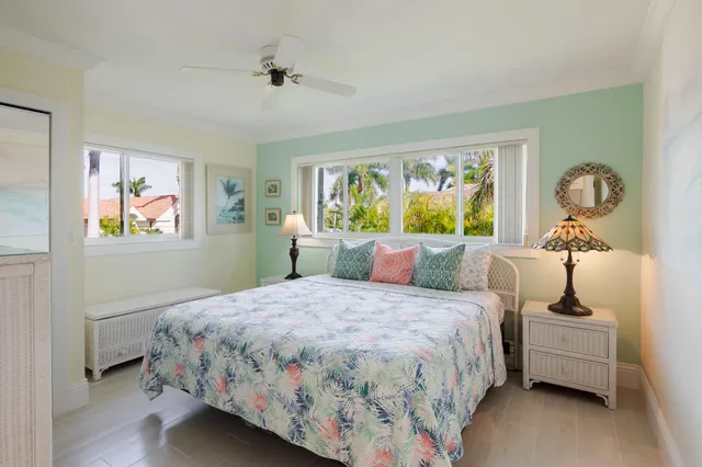 a bedroom with a large bed and wooden floor