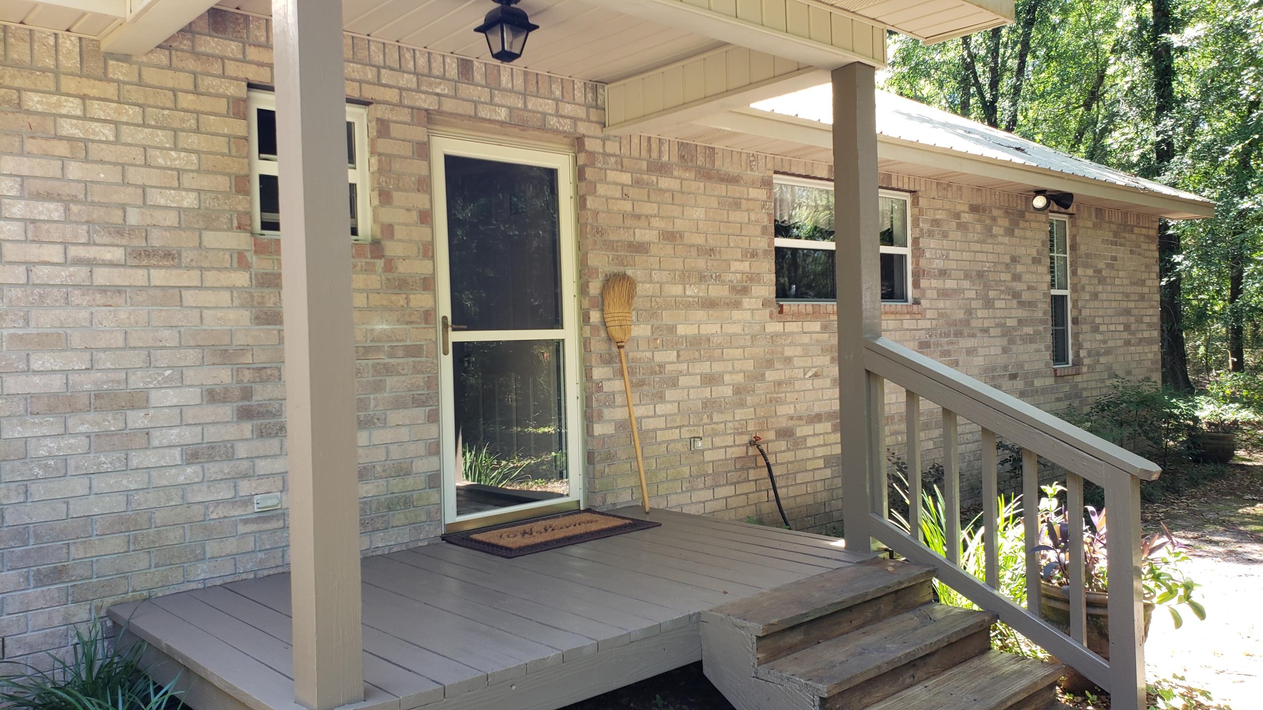 564 Harbuck Road DeFuniak Springs, FL 32433 - Photo 11 of 19 a view of balcony with wooden floor and outdoor seating