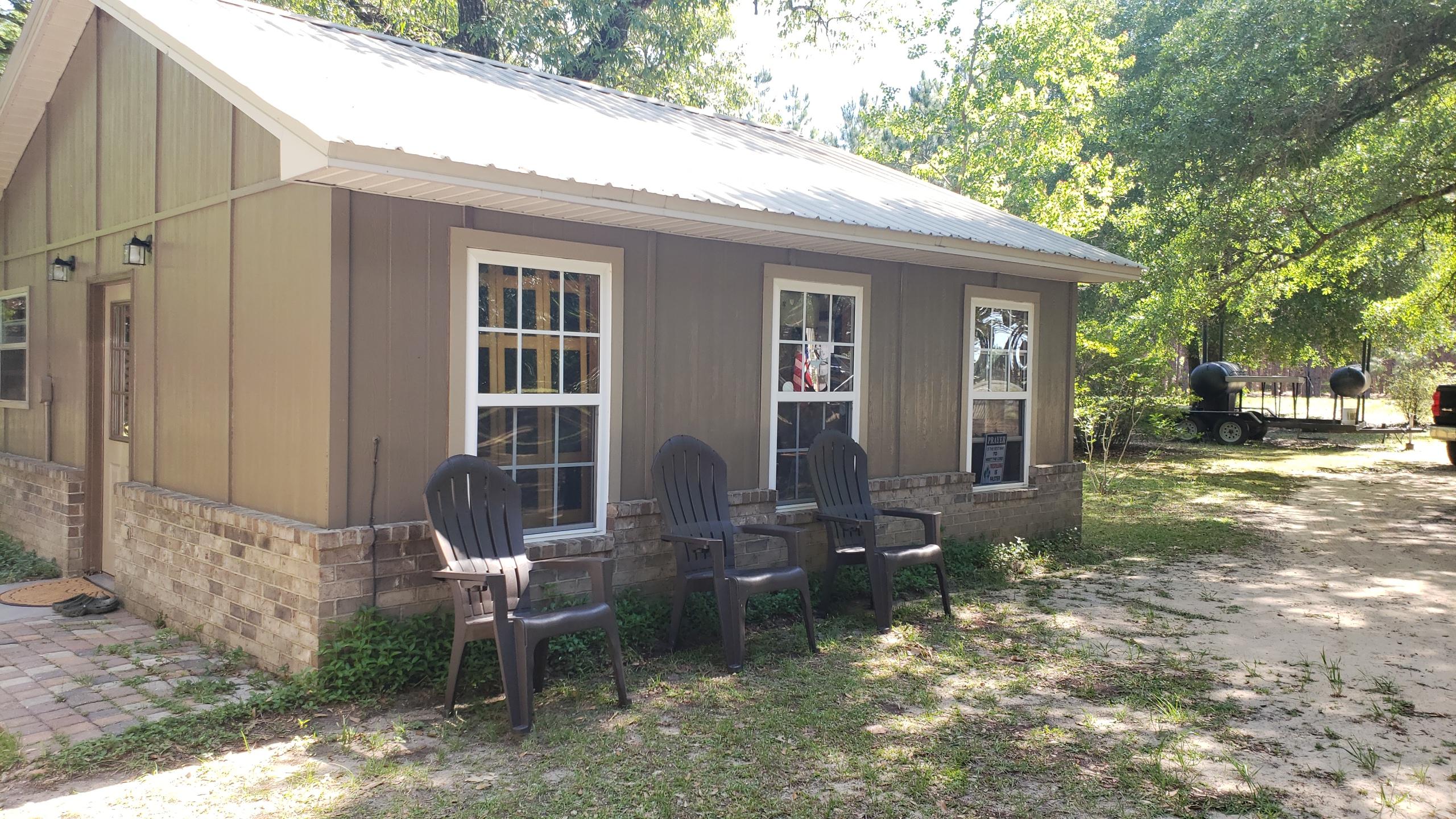 564 Harbuck Road DeFuniak Springs, FL 32433 - Photo 13 of 19 a view of a house with backyard sitting area and garden