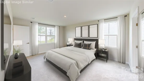 a bedroom with a bed and a large window