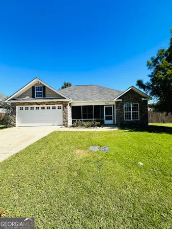 a front view of a house with a garden