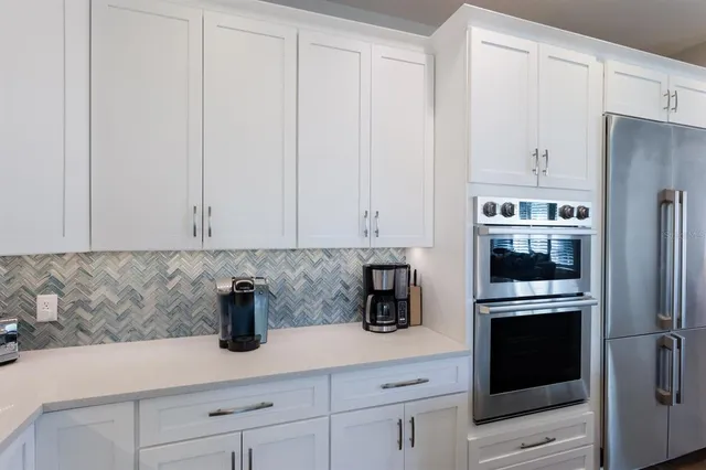 a living room with furniture a flat screen tv and a large window