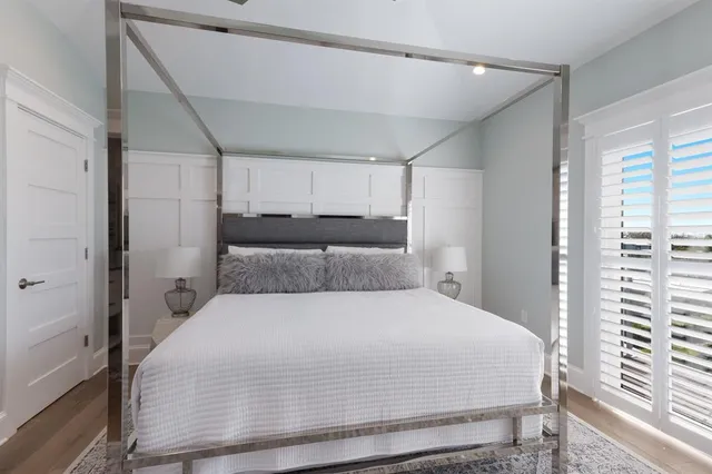 a bathroom with a granite countertop sink a toilet a mirror and shower