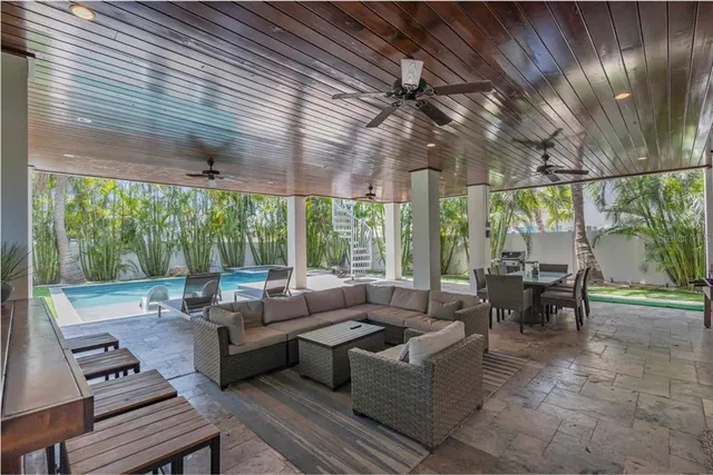 a swimming pool with patio outdoor seating and yard