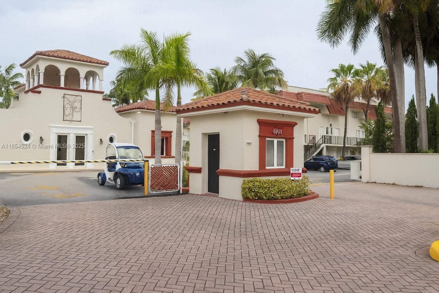 8650 Southwest 67th Avenue, Unit 1032 Pinecrest, FL 33156 - Photo 15 of 16 a front view of a house with garden