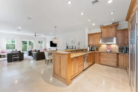 a large kitchen with stainless steel appliances lots of counter top space