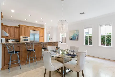 a view of a dining room with furniture and chandelier