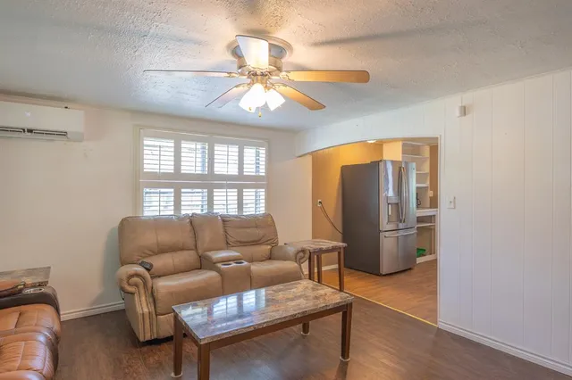 a living room with furniture a chandelier and a window