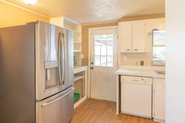 a kitchen with stainless steel appliances a refrigerator and a sink