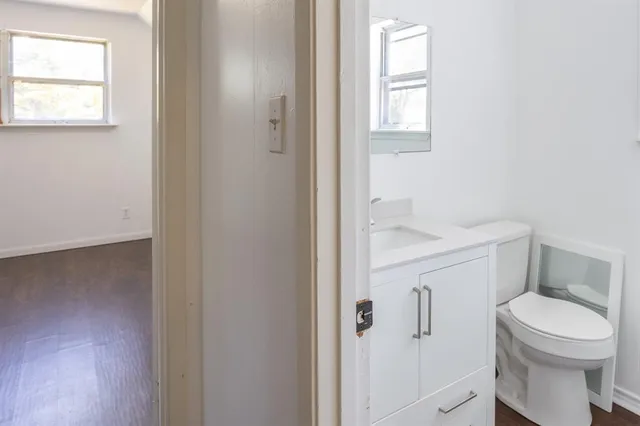 a white toilet sitting next to a bathroom sink