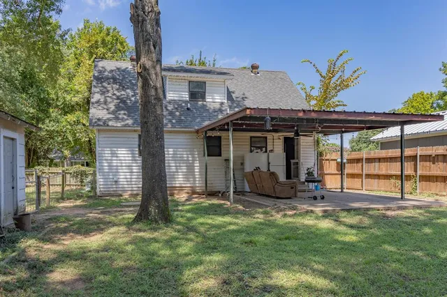 a view of a house with a small yard and floor to ceiling window