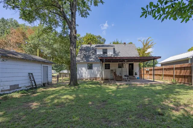a view of a house with a yard and sitting area
