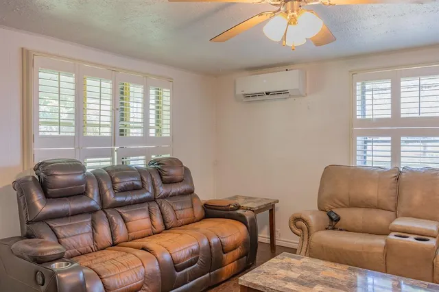 a blue couch sitting in a living room next to a window