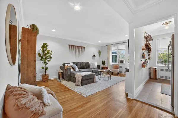 a living room with furniture a couch and a chandelier