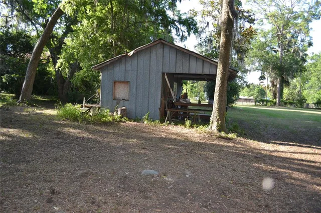 a view of a house with yard and a tree