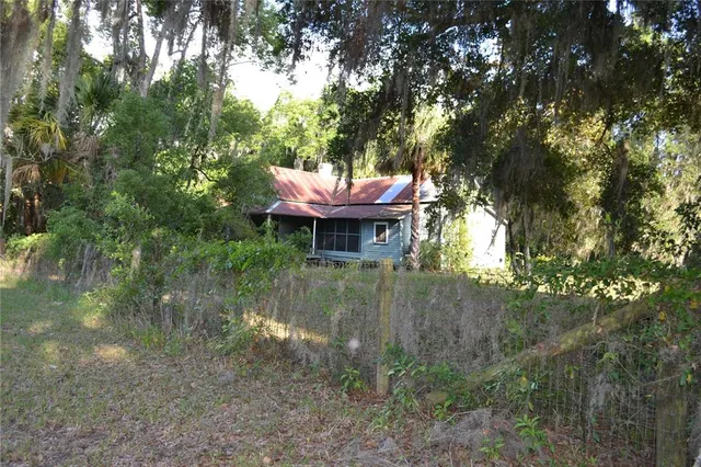 a view of a fire pit with large trees