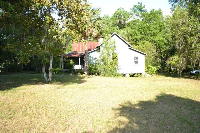 a view of a house with pool and sitting area