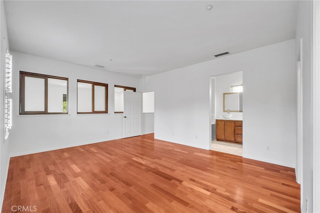 130 Roadrunner Irvine, CA 92603 - Photo 27 of 36 a view of empty room with wooden floor and fan